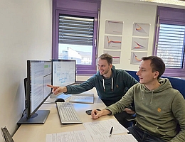 Dr. Sebastian Wolfschmidt (hinten) und Christopher Staub arbeiten gemeinsam an der Berechnung des Langzeitverhaltens von Galaxien. (Foto: Lisa Krügel/Universität Bayreuth)